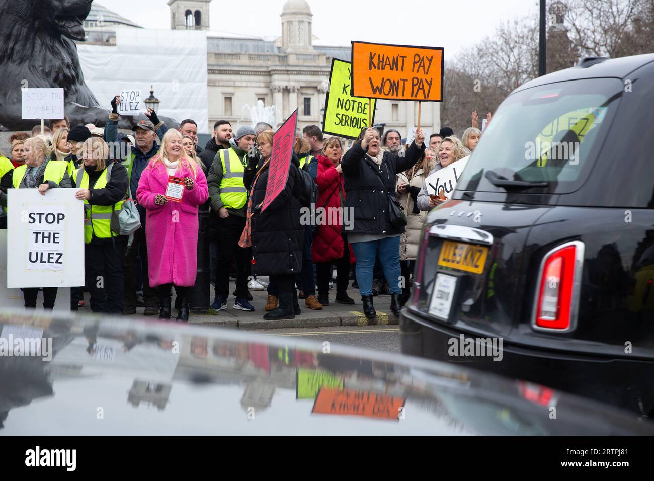 Participants gather with placards during a protest against the expansion of London's ultra-low emission zone (ULEZ) around Trafalgar Square in London. Stock Photo
