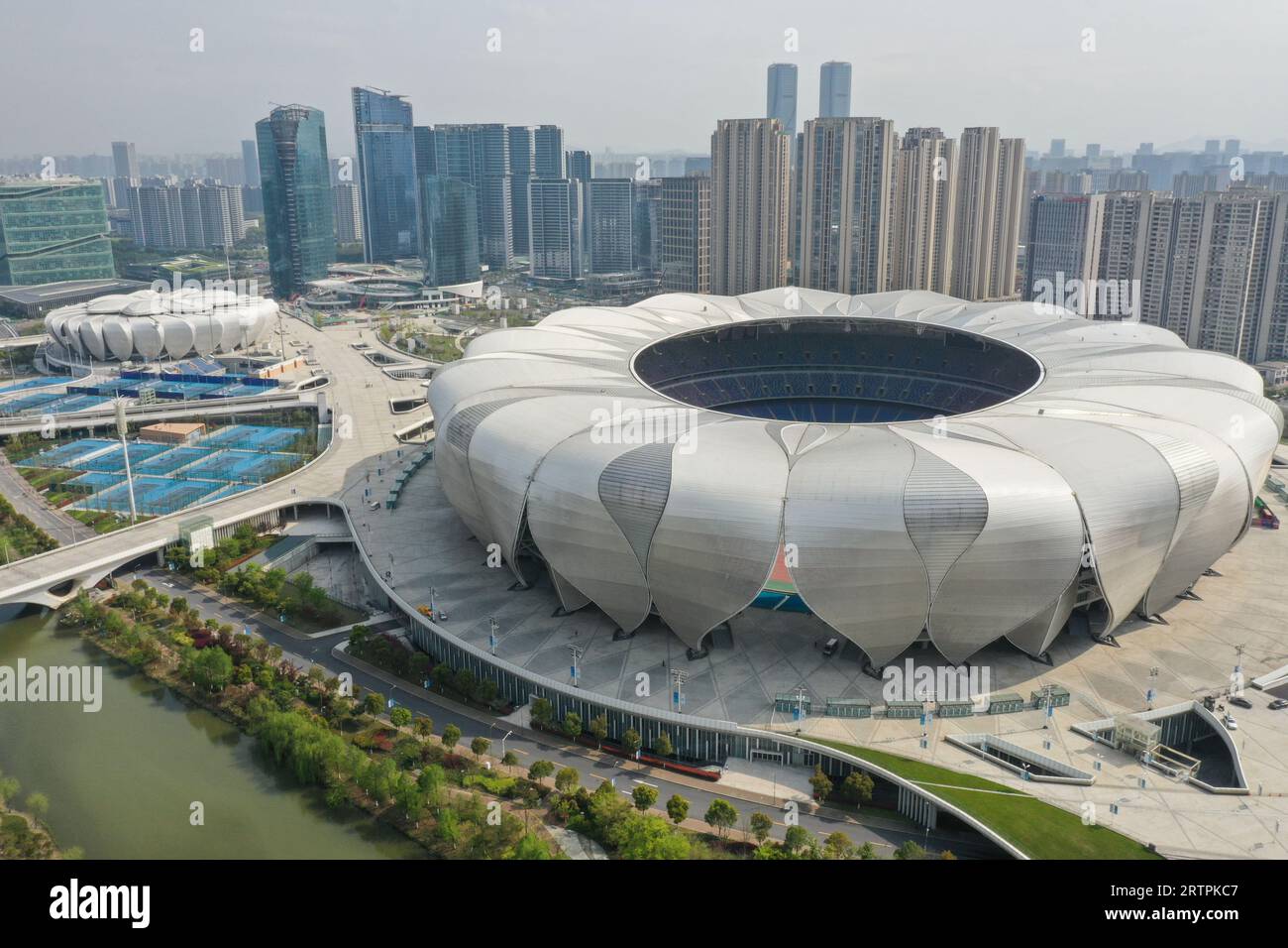 Hangzhou. 30th Mar, 2022. This aerial photo taken on March 30, 2022 shows the Hangzhou Olympic Sports Center's main stadium (R) and Tennis Center in Hangzhou, east China's Zhejiang Province. The 19th Asian Games will take place in Hangzhou between September 23 and October 8, featuring a total of 40 sports. It will be the third Asian Games to be hosted in China, after Beijing 1990 and Guangzhou 2010. The highly anticipated Asian Games can help boost the popularity of Hangzhou where history and modernity co-exist and further promote its culture. Credit: Huang Zongzhi/Xinhua/Alamy Live News Stock Photo