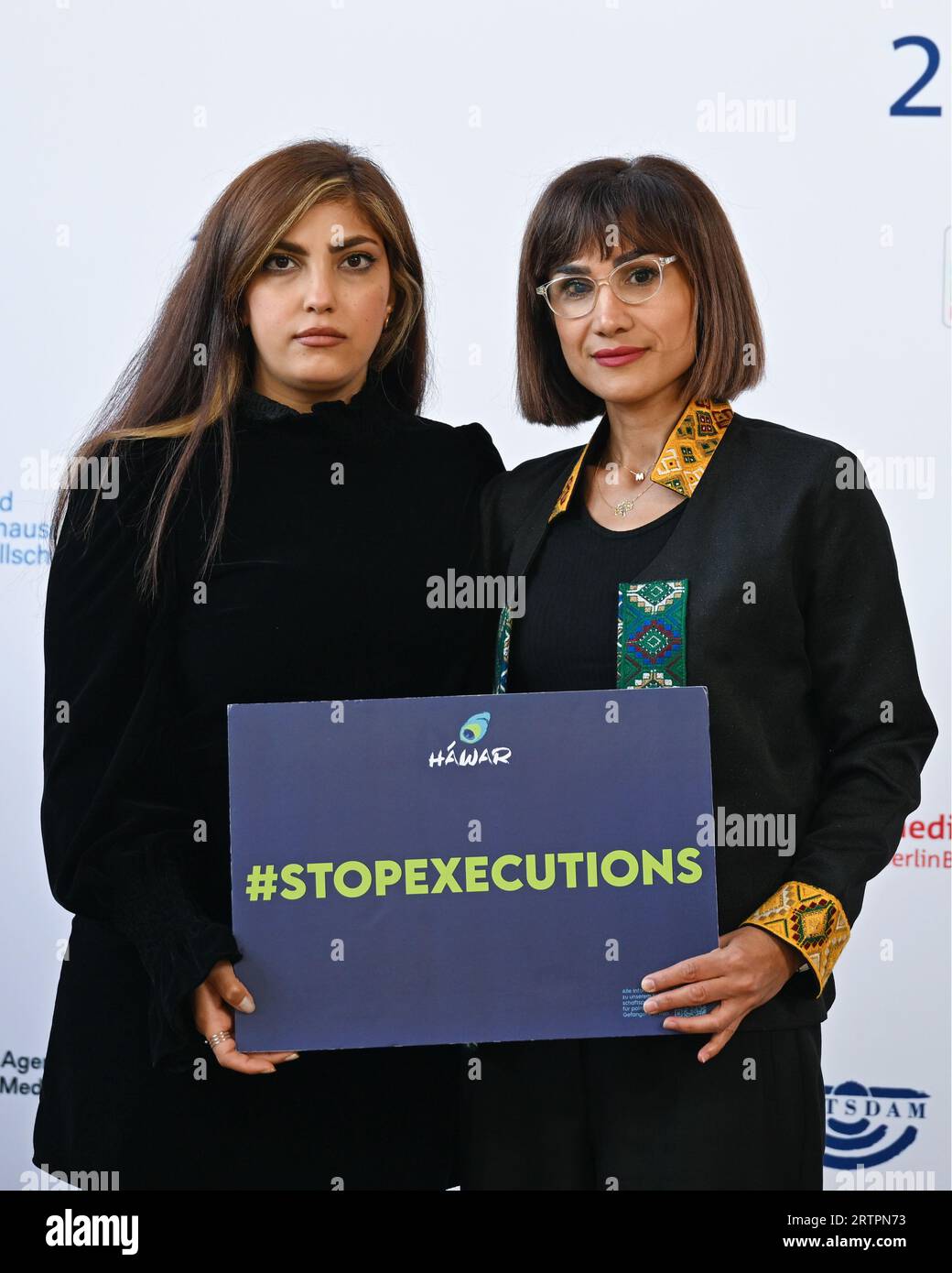 Potsdam, Germany. 14th Sep, 2023. Mersedeh Shahinkar (r), Iranian activist, and Shima Babaei (l), Iranian women's rights activist, hold a sign reading '#stopexecutions' before the start of the M100 Media Awards ceremony. The M100 Media Award has been presented since 2005 as part of the international media conference M100 Sanssouci Colloquium. Credit: Soeren Stache/dpa/Alamy Live News Stock Photo