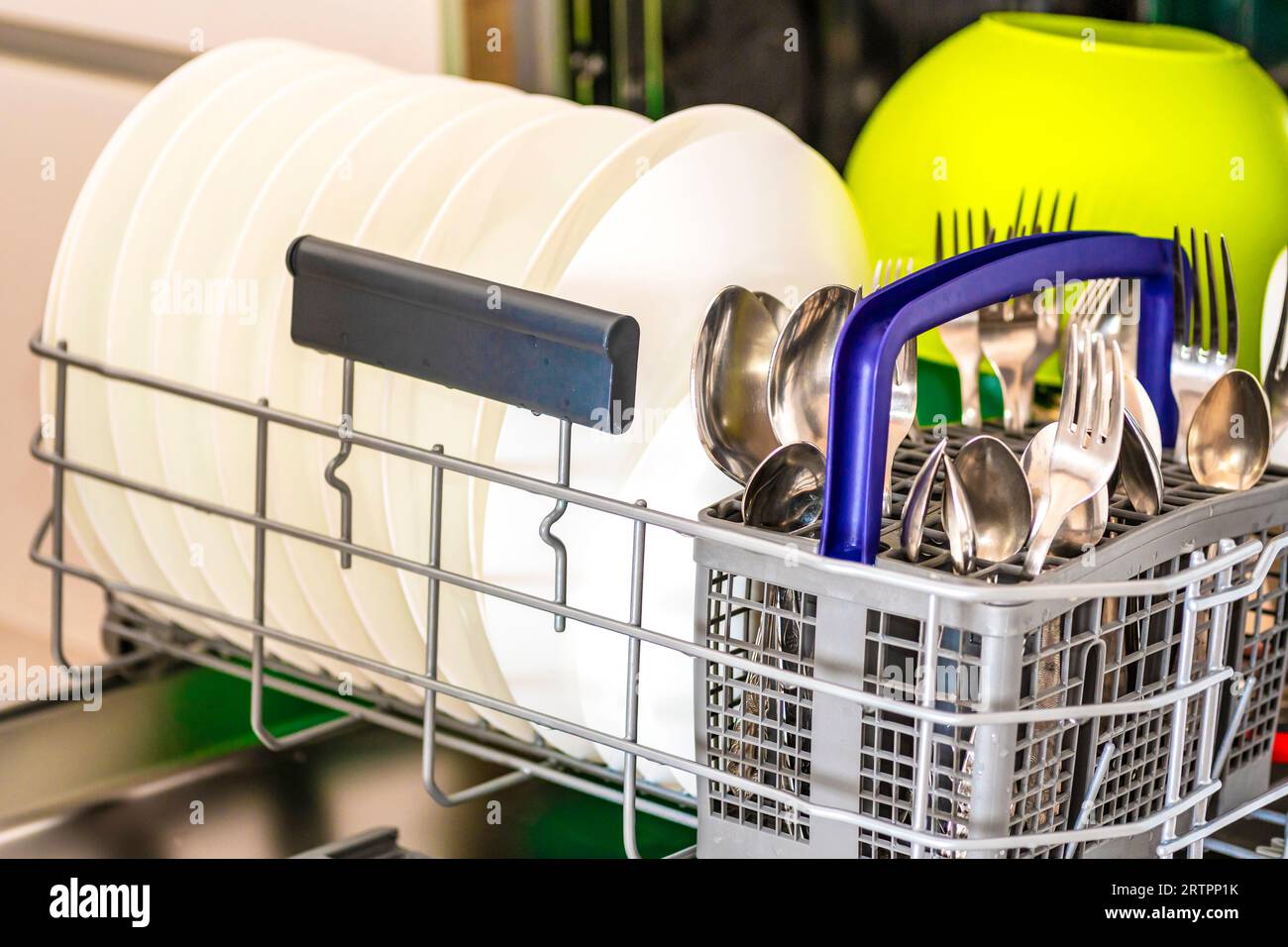 Open dishwasher. The washed dishes. Clean cutlery. Kitchen hygiene