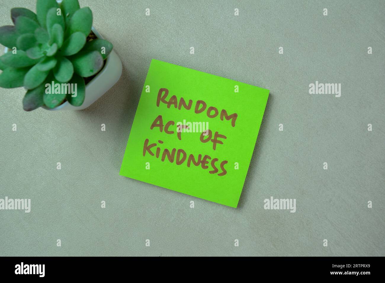 Concept of Random Act of Kindess write on sticky notes isolated on Wooden Table. Stock Photo