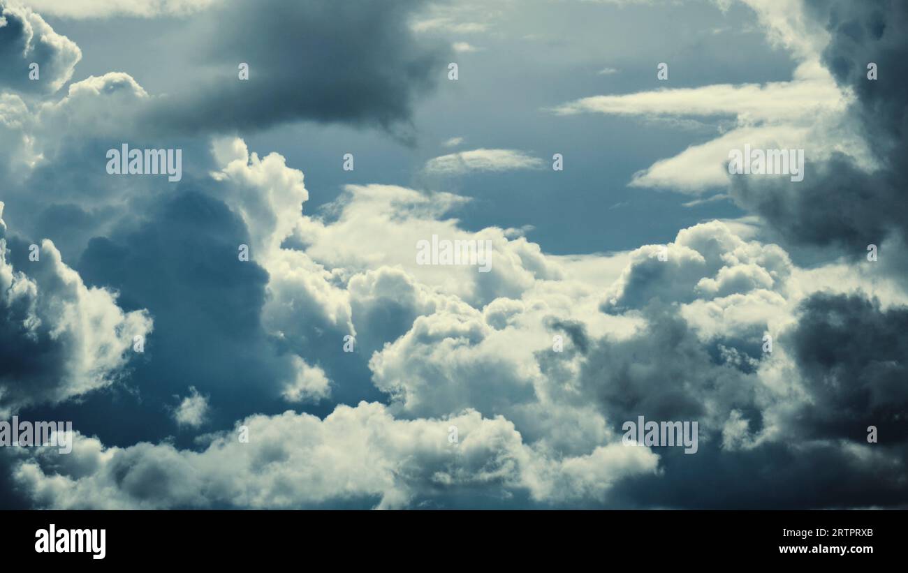 Dark storm clouds with breaking sunlight Stock Photo