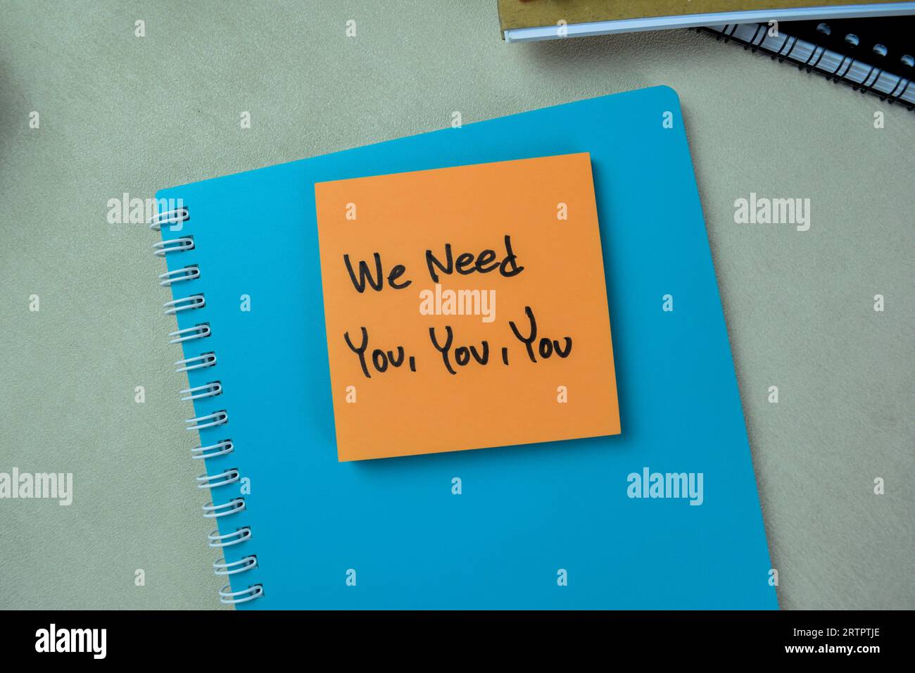 Concept of We Need You, You, You write on sticky notes isolated on Wooden Table. Stock Photo