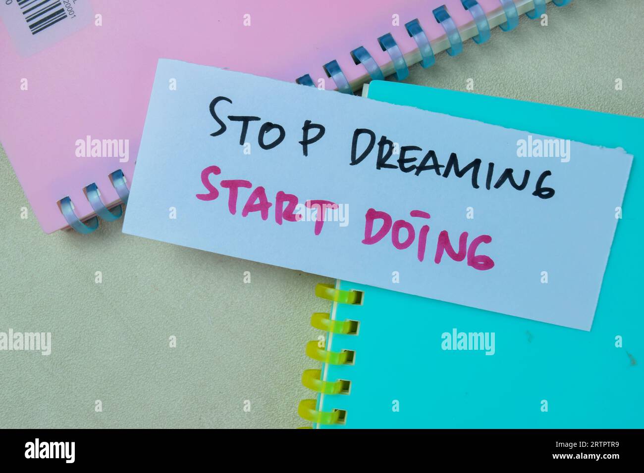 Concept of Stop Dreaming Start Doing write on sticky notes isolated on Wooden Table. Stock Photo