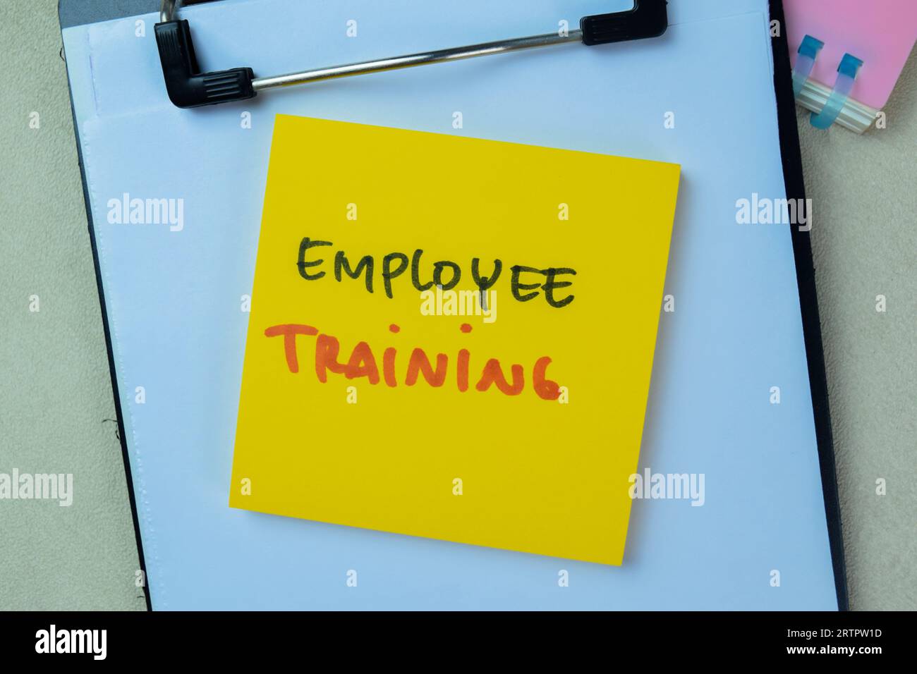Concept of Employee Training write on sticky notes isolated on Wooden Table. Stock Photo