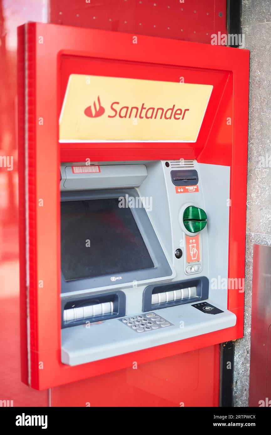 Viladecans, Spain - September 14, 2023: Santander bank ATM with its advertising outside the bank office. Stock Photo