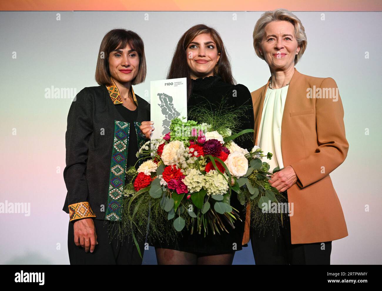 Potsdam, Germany. 14th Sep, 2023. Mersedeh Shahinkar (l), Iranian activist, and Shima Babaei (m), Iranian women's rights activist, are happy about the award after receiving the M100 Media Award next to Ursula von der Leyen (r), President of the European Commission. The Iranians accept the award on behalf of the Iranian 'Women, Life, Freedom' movement. The M100 Media Award has been presented since 2005 as part of the international media conference M100 Sanssouci Colloquium. Credit: Soeren Stache/dpa/Alamy Live News Stock Photo