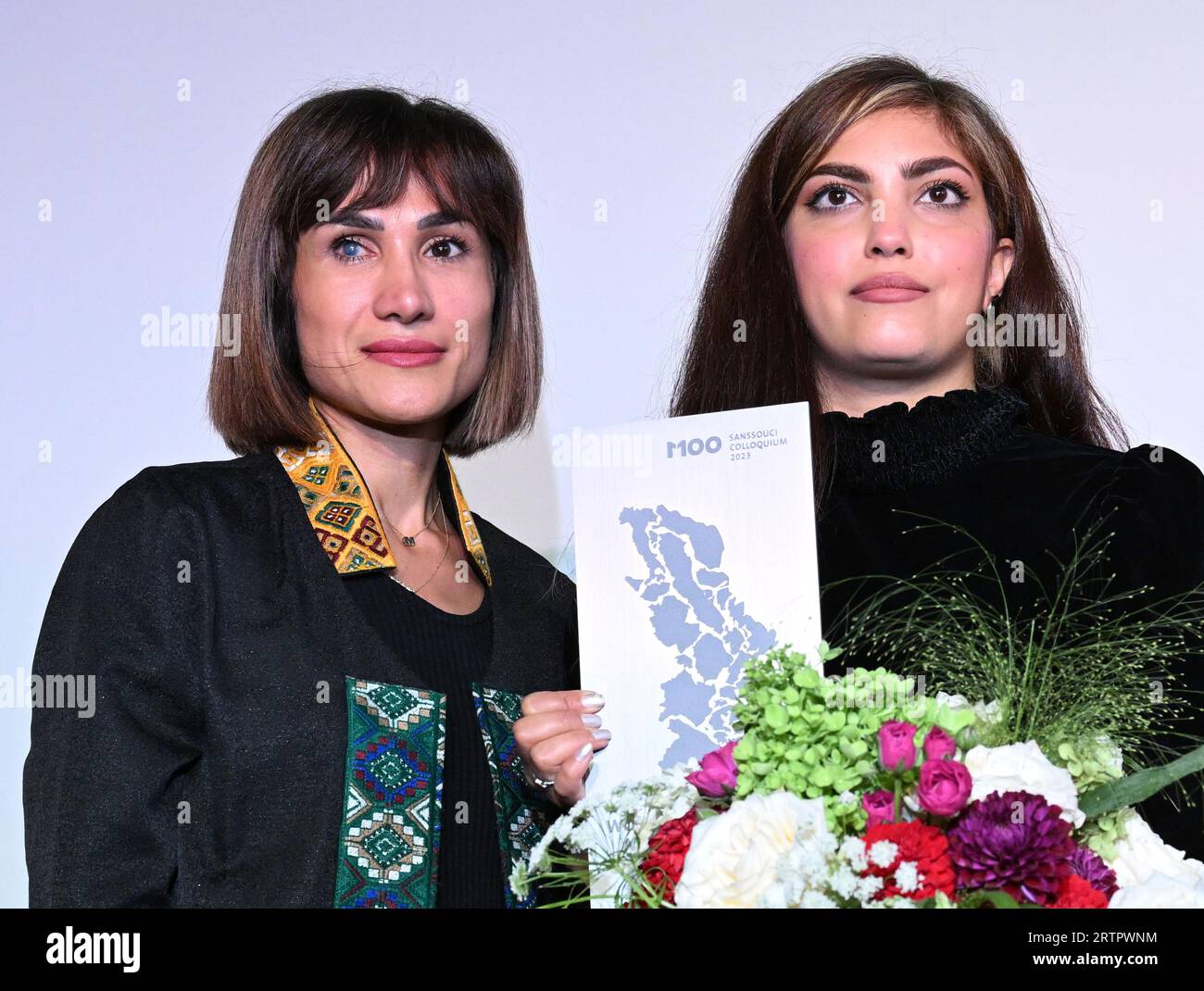 Potsdam, Germany. 14th Sep, 2023. Mersedeh Shahinkar (l), Iranian activist, and Shima Babaei (m), Iranian women's rights activist, are happy about the award after receiving the M100 Media Award. The Iranians accept the award on behalf of the Iranian 'Women, Life, Freedom' movement. The M100 Media Award has been presented since 2005 as part of the international media conference M100 Sanssouci Colloquium. Credit: Soeren Stache/dpa/Alamy Live News Stock Photo
