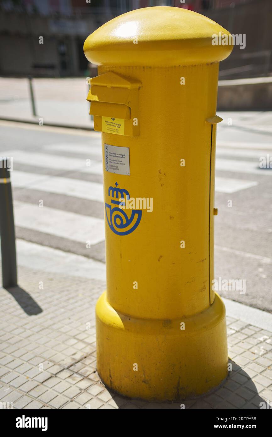 Viladecans, Spain - September 14, 2023: Yellow mailbox for sending postal letters of the Spanish state-owned company Correos y Tel egrafos, located in Stock Photo