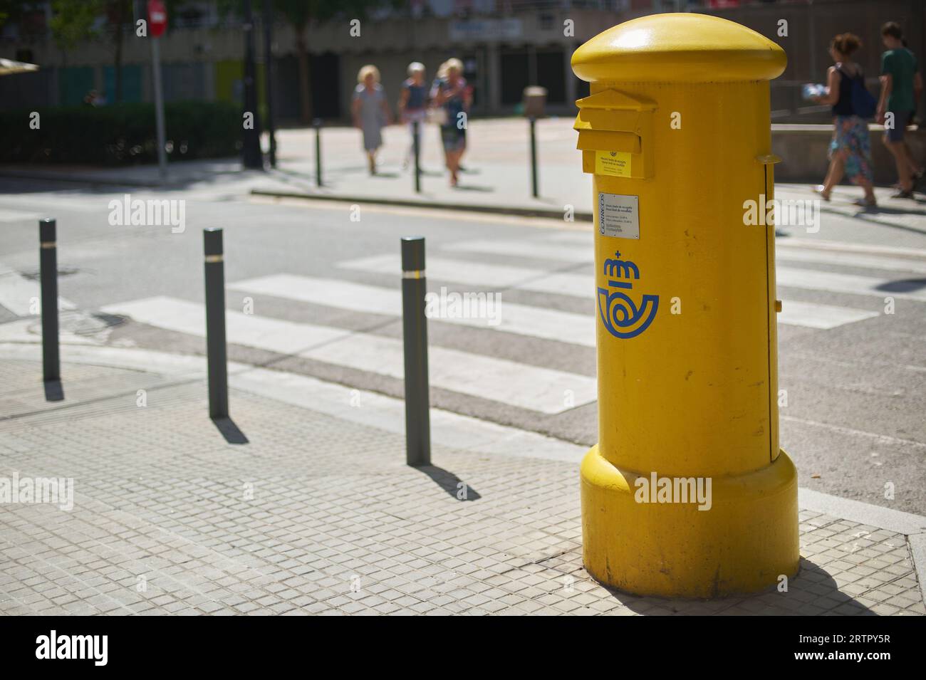Viladecans, Spain - September 14, 2023: Yellow mailbox for sending postal letters of the Spanish state-owned company Correos y Tel egrafos, located in Stock Photo