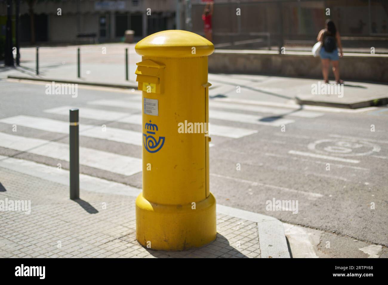 Viladecans, Spain - September 14, 2023: Yellow mailbox for sending postal letters of the Spanish state-owned company Correos y Tel egrafos, located in Stock Photo