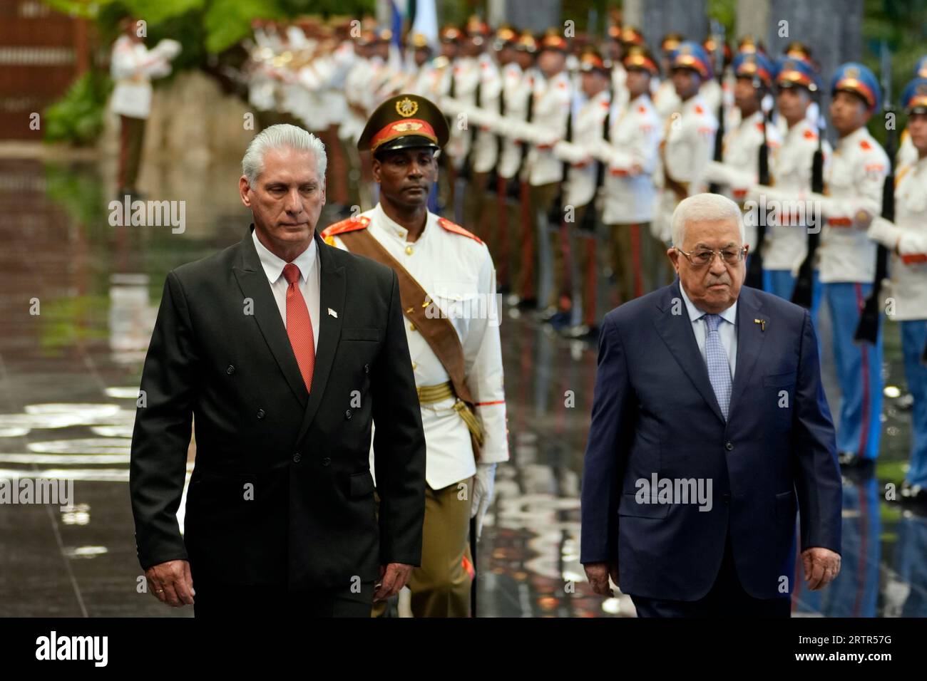 Cuban President Miguel Diaz-Canel, left, walks with Palestinian ...