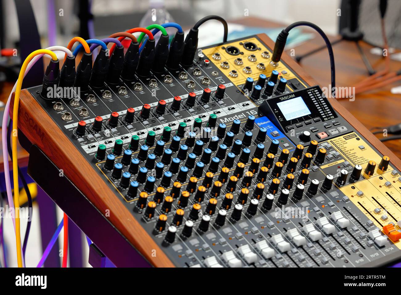 A Tascam Model 16 studio mixer interface and multitrack recording device with colored XLR microphone inputs attached. Stock Photo