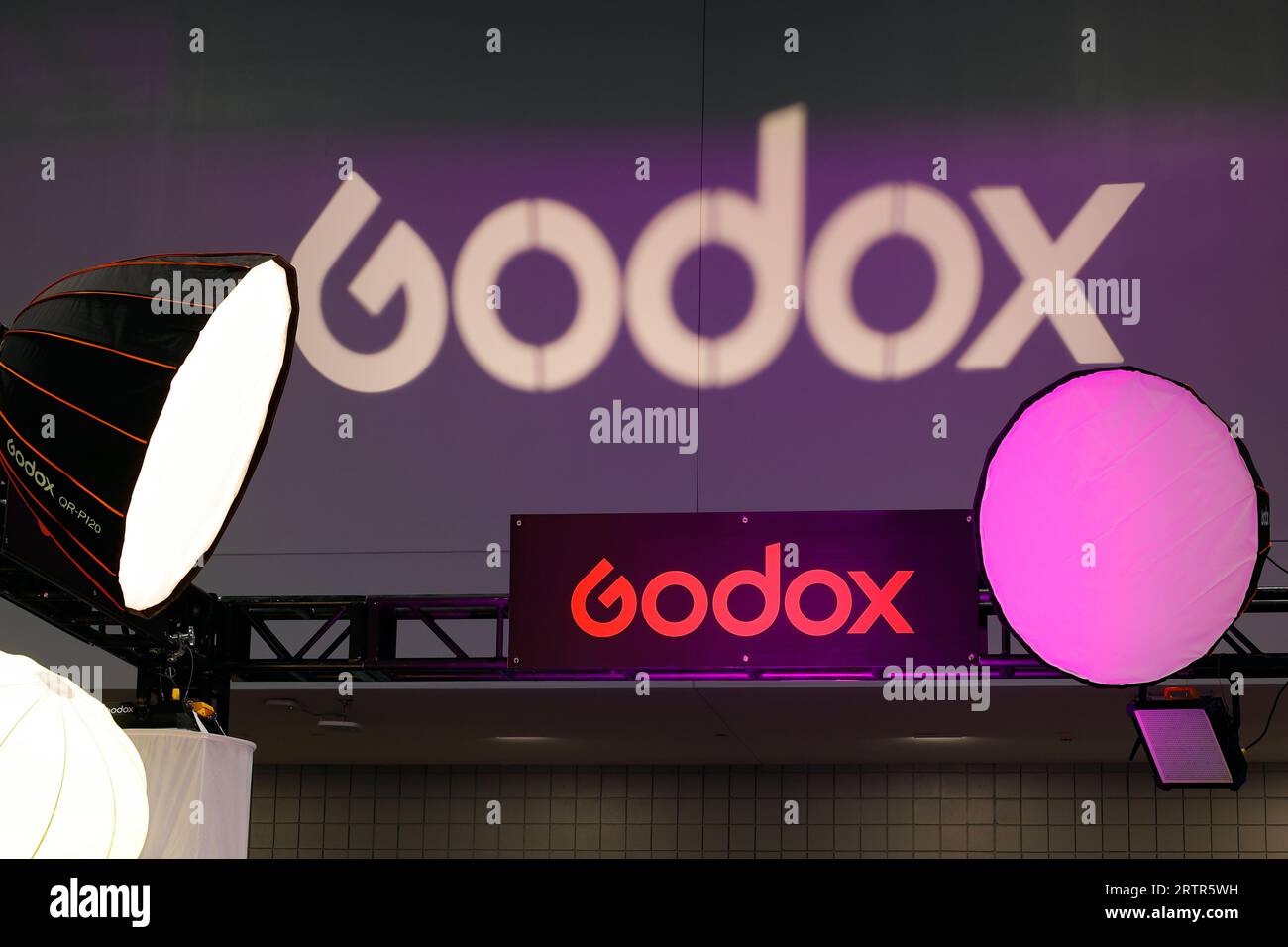 Signage for Godox photographic studio lighting equipment at a trade show exhibition. Stock Photo