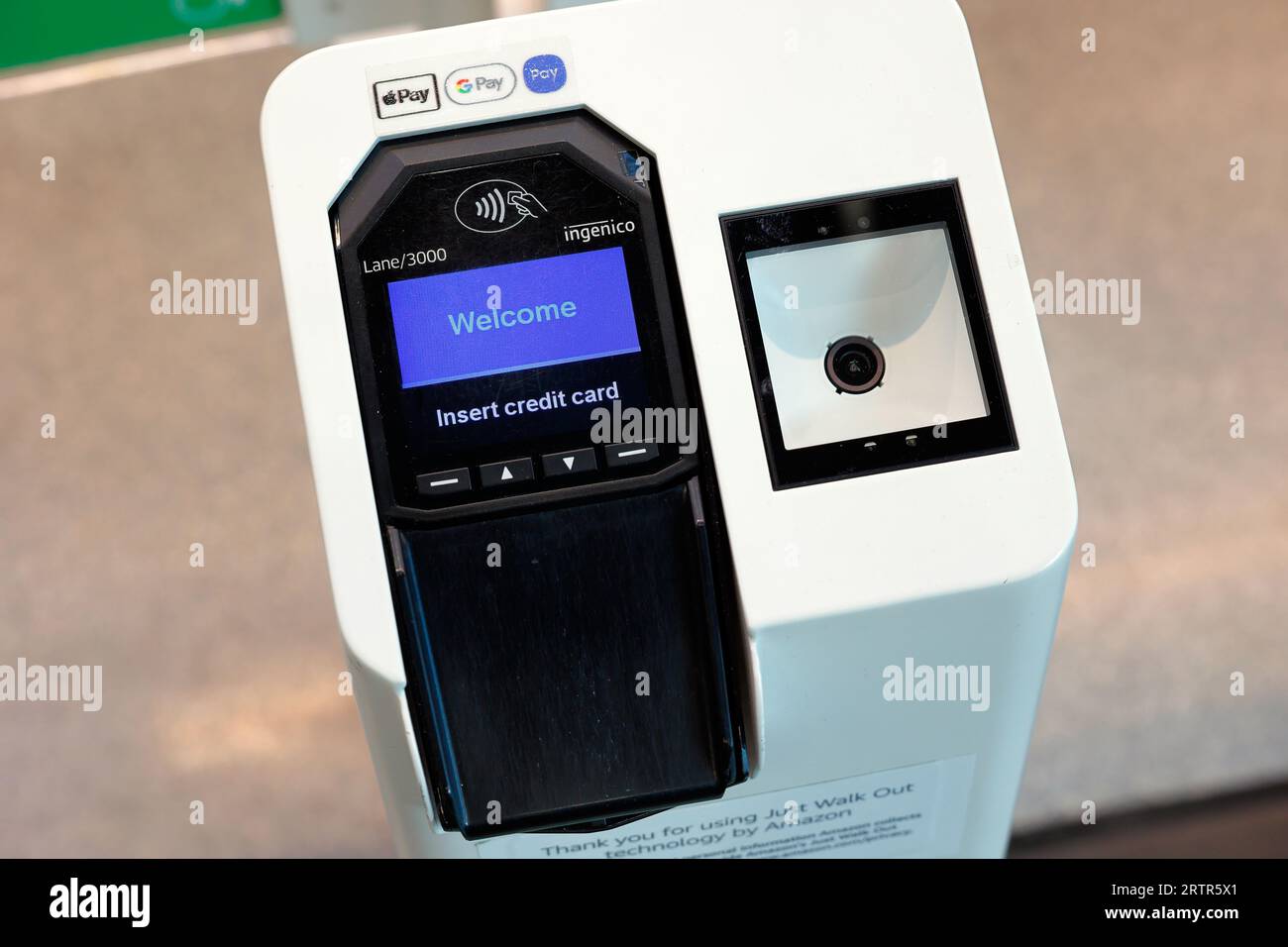 An Amazon Just Walk Out credit card terminal and QR code scanner at the entrance of a third party retailer. Stock Photo