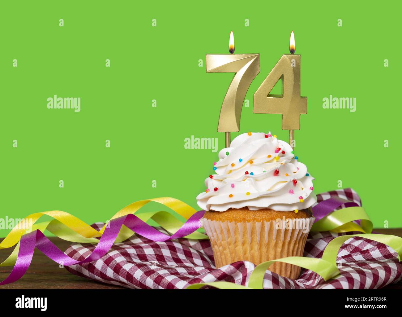 Birthday Cake With Candle Number 74 On Green Background Stock Photo