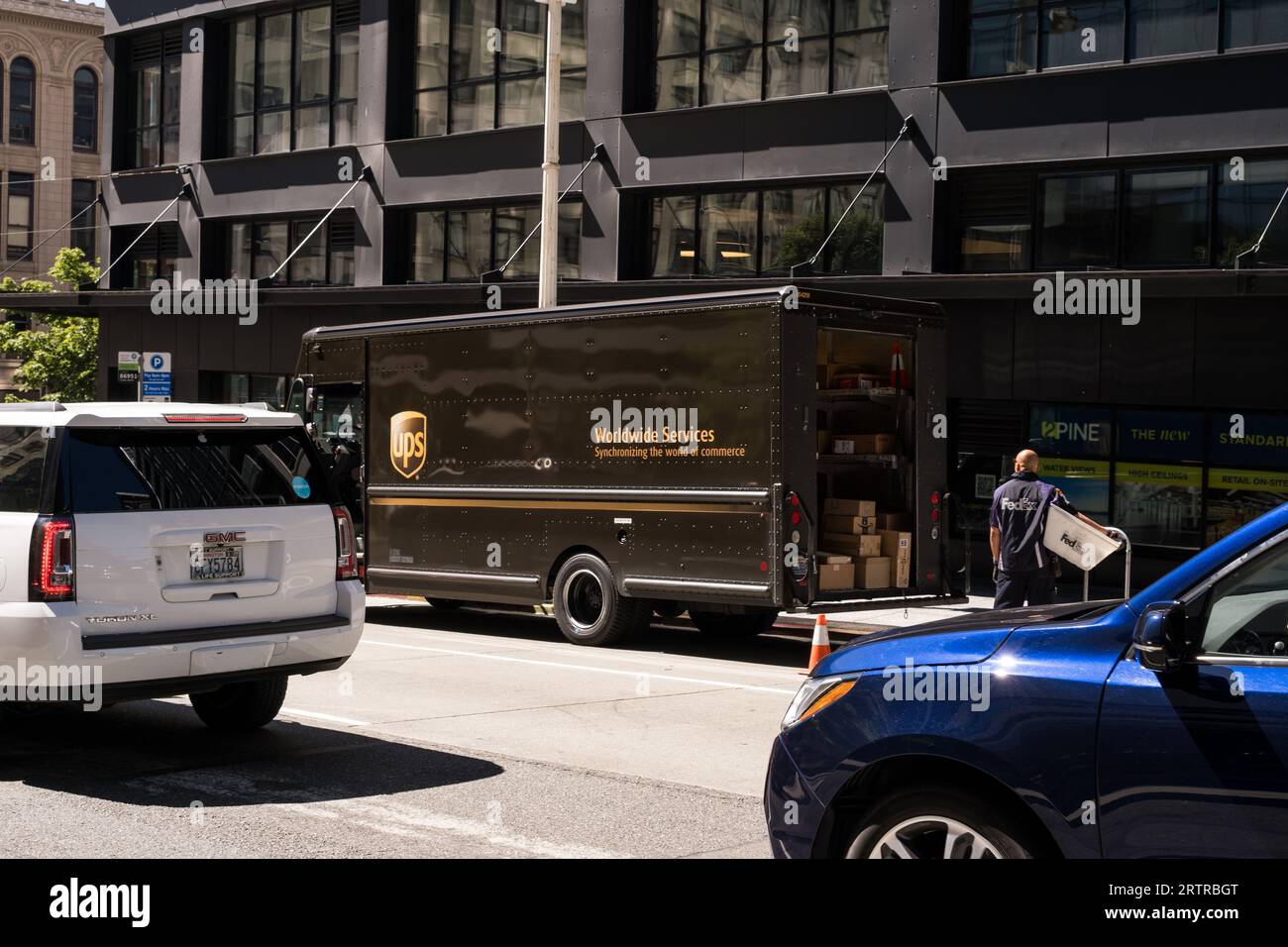 Seattle, USA. 3 Aug, 2023. UPS and FedEx driver chatting in downtown. Stock Photo