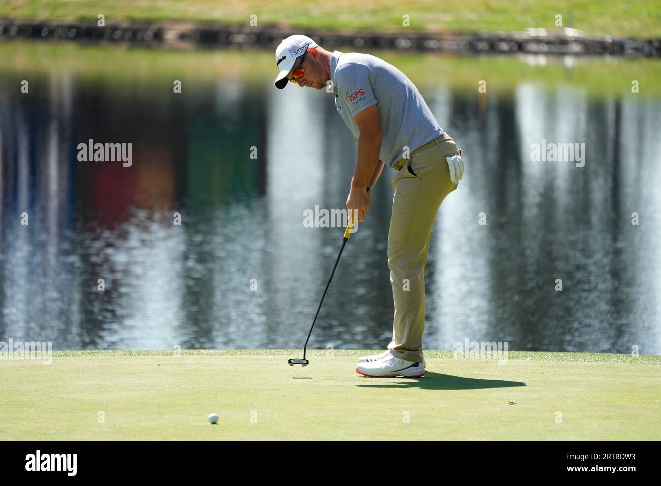 Lucas Herbert, of Australia, makes a birdie putt on the 17th green of