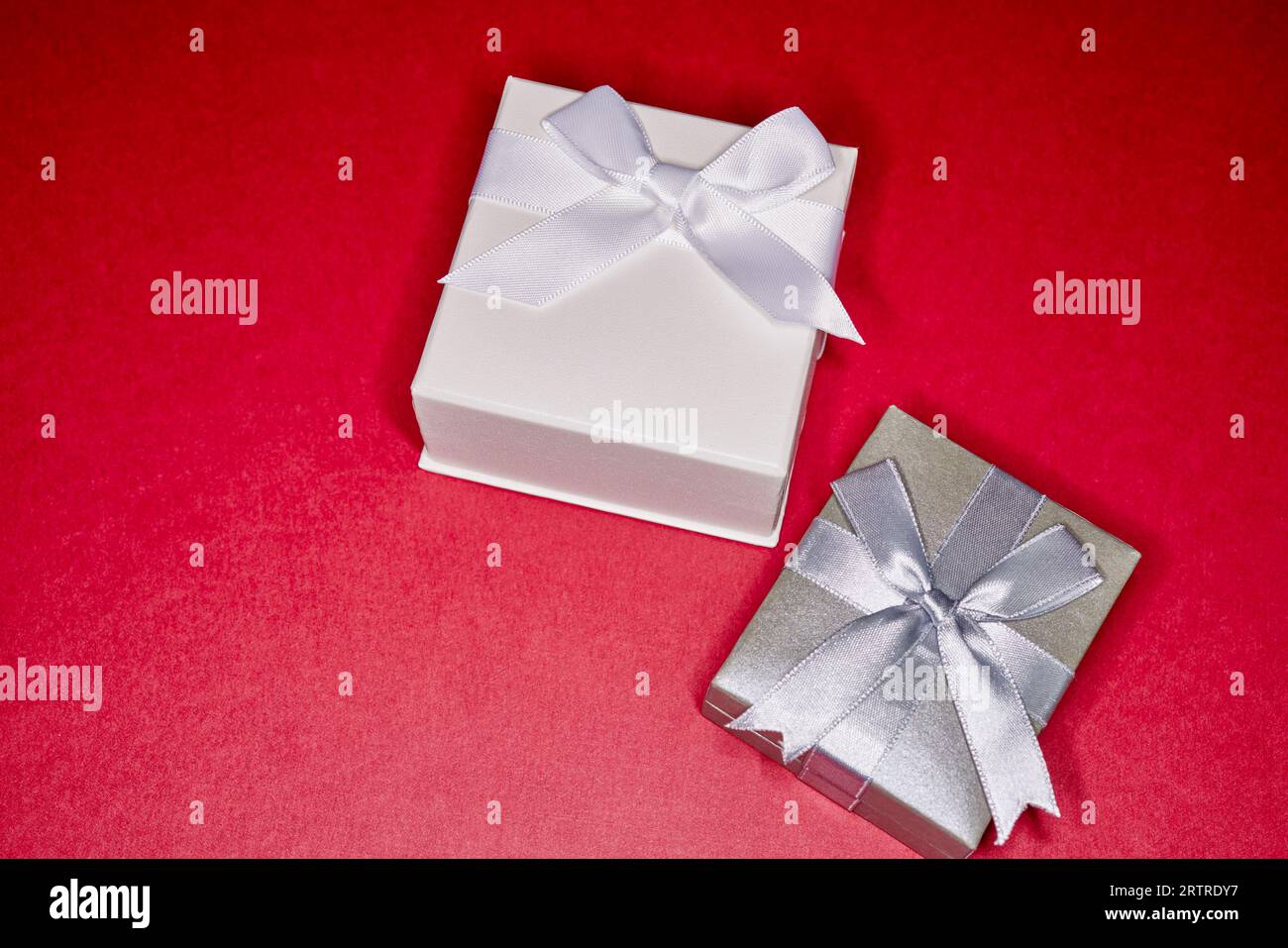 Gift boxes with red ribbon bows on white background Stock Photo - Alamy