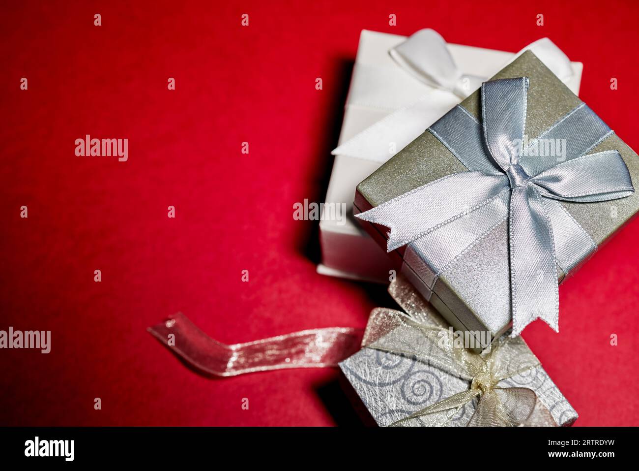 Various Gift Boxes with Ribbon and Bows isolated on Red Stock Photo