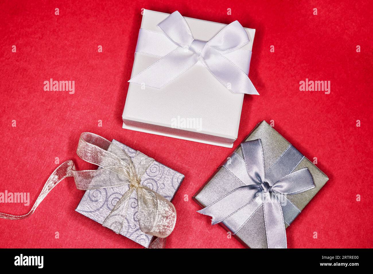 Various Gift Boxes with Ribbon and Bows isolated on Red Stock Photo