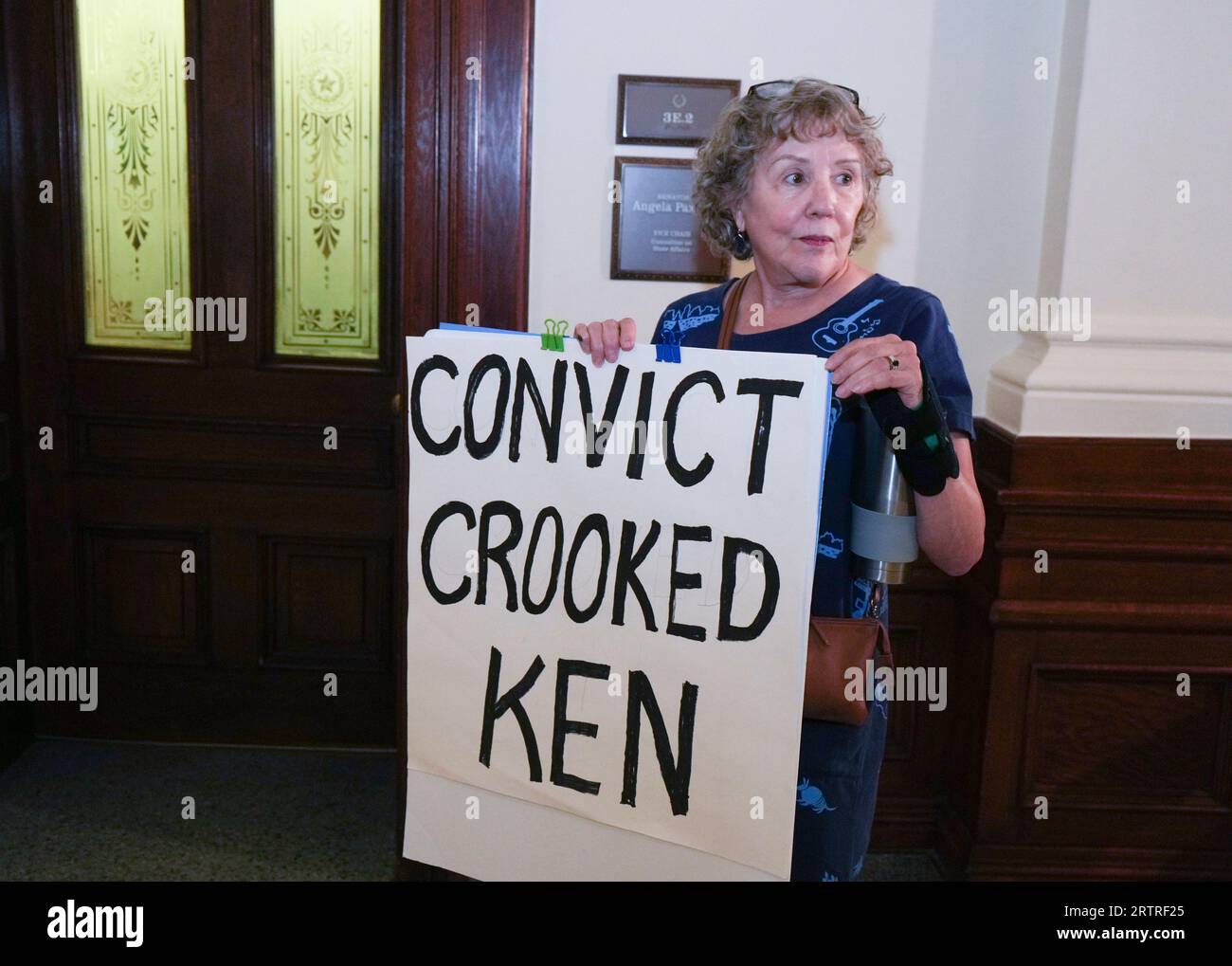Protester ELLEN MCCLUSKEY stands outside the Senate office of Sen. Angela Paxton (not shown) with a sign against her husband during an afternoon break on day eight in Texas Attorney General Ken Paxton's impeachment trial in the Texas Senate on September 14, 2023. Credit: Bob Daemmrich/Alamy Live News Stock Photo