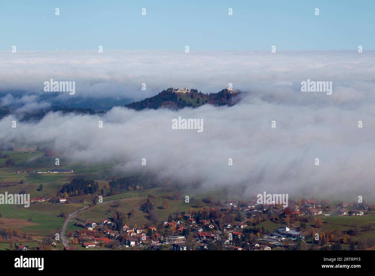 The castle ruins Hohenfreyberg and Eisenberg above the fog in the Allgaeu in Bavaria, Germany. The Hohenfreyberg and Eisenberg castle ruins above the Stock Photo