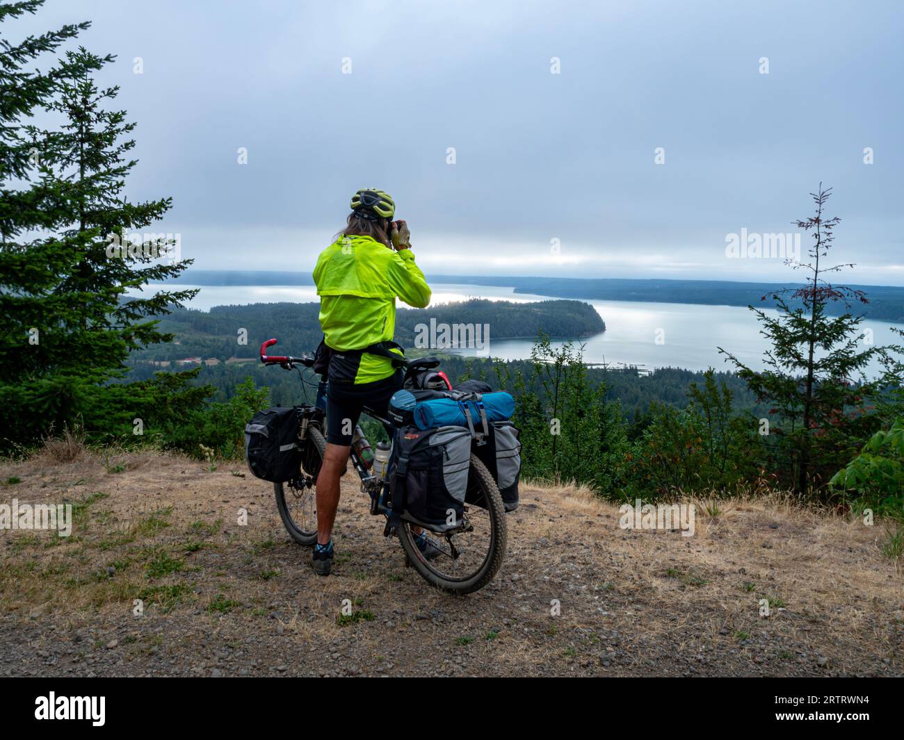 WA23697-00...WASHINGTON - Tom Kirkendall photographing the Hood Canal while riding Forest Road 2620  on the Olympic Bikepacking from the Top Route. Stock Photo