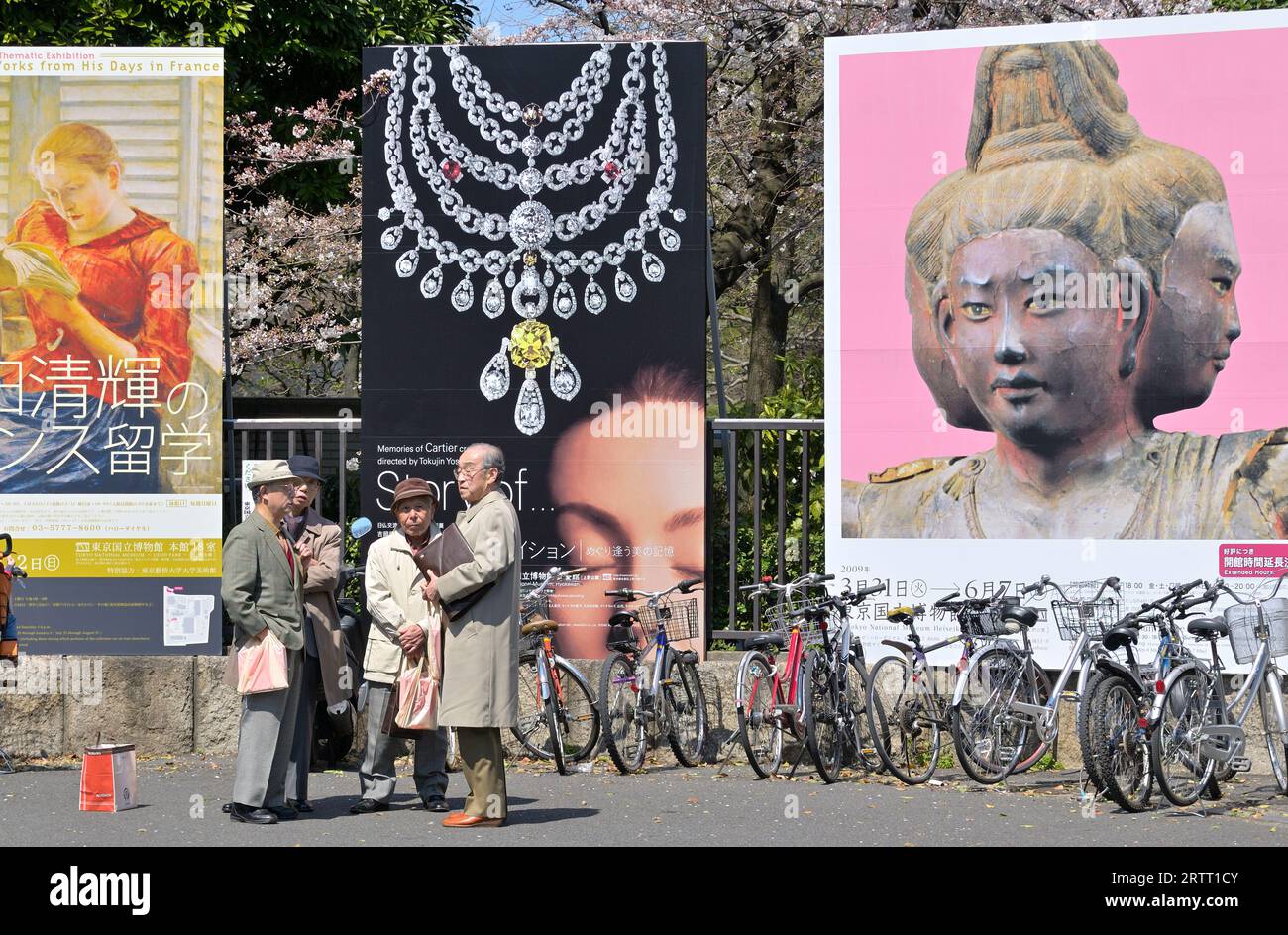 Japanese elderly men standing in front of a billboard at Tokyo National Museum, Tokyo Ueno, Japan JP Stock Photo