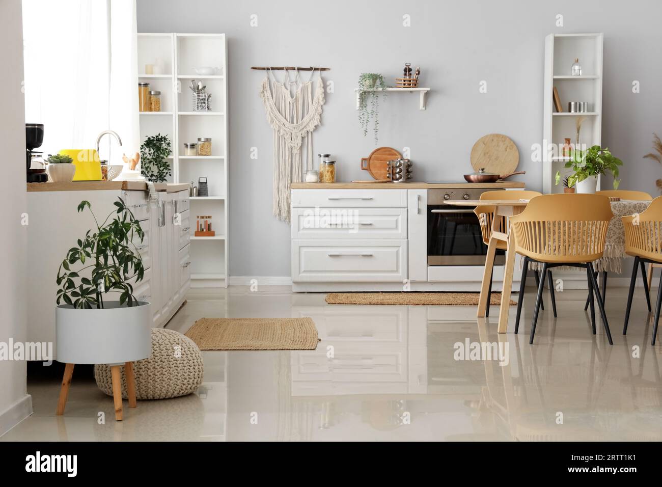 Interior of light kitchen with white counters and wicker carpets Stock ...