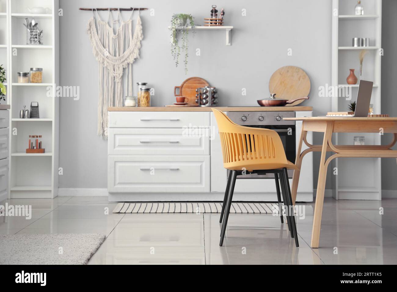 Interior of light kitchen with white counters and dining table Stock ...