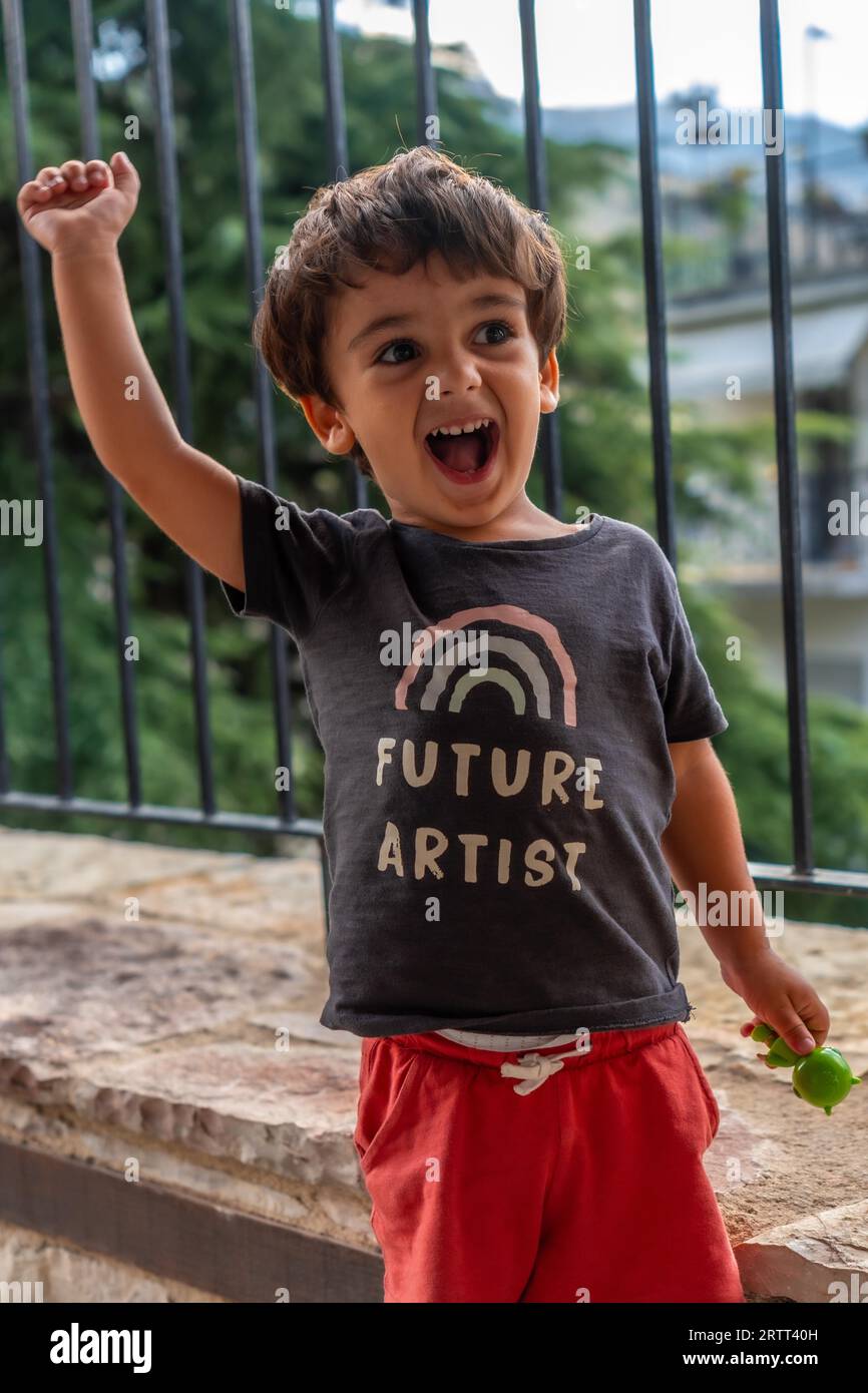 Portrait of a very cheerful two year old boy enjoying the summer