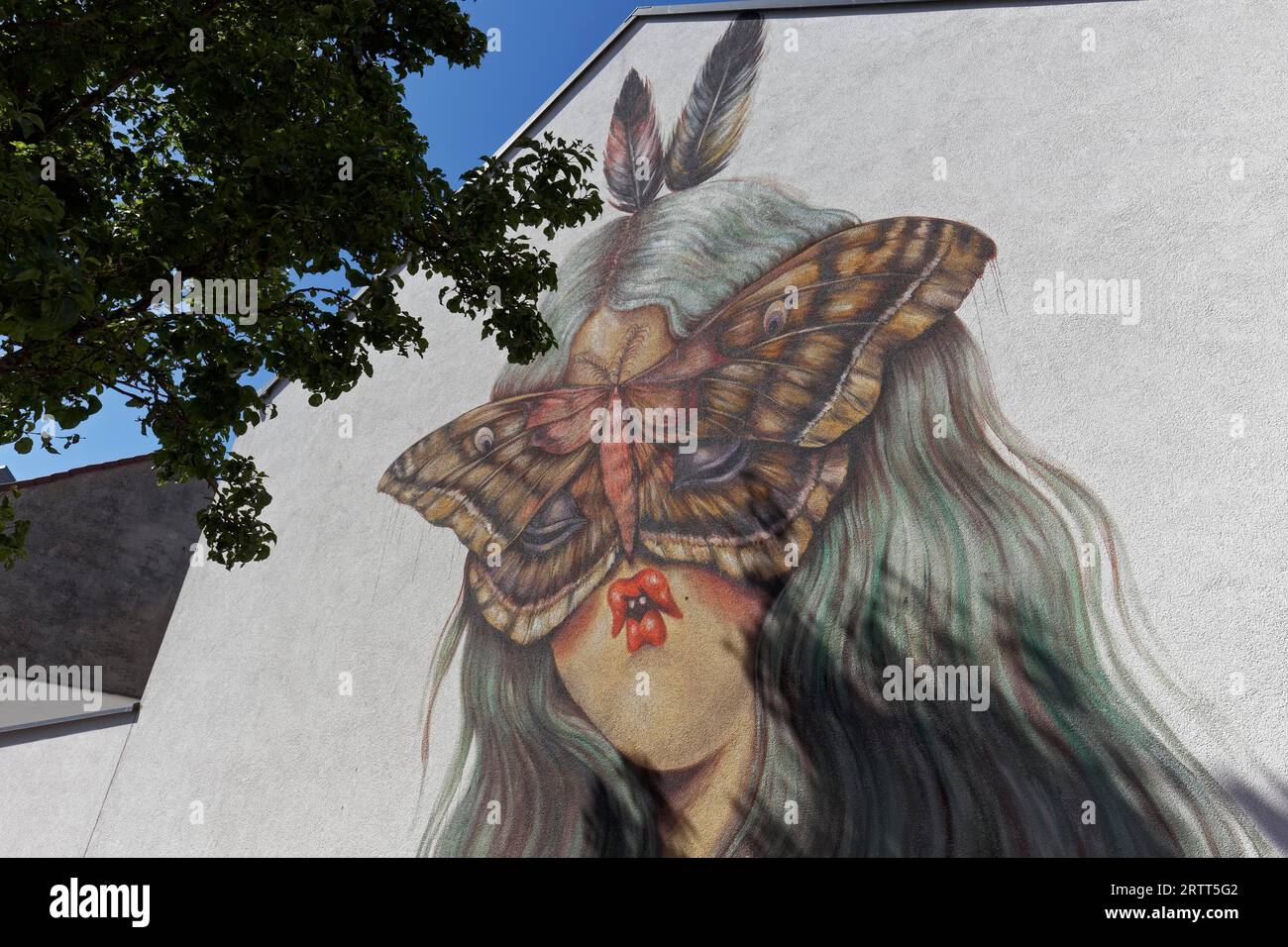 Portrait of a woman with pointed lips and butterfly in front of her face, surreal mural by street artist Miss Van, Ostend, Belgian coast, West Stock Photo