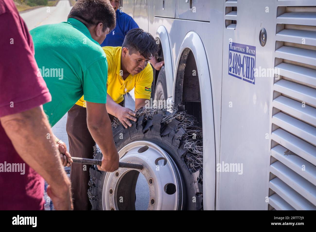 Puerto Suarez, Bolivia on August 21, 2015: Mechanic changing flat tire ...