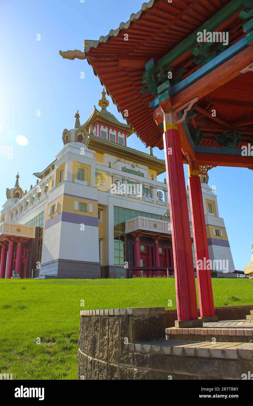 Buddhist temple Golden Abode of Buddha Shakyamuni against a blue sky with the alcove at the foreground. Elista, Kalmykia, Russia, copy space for text Stock Photo