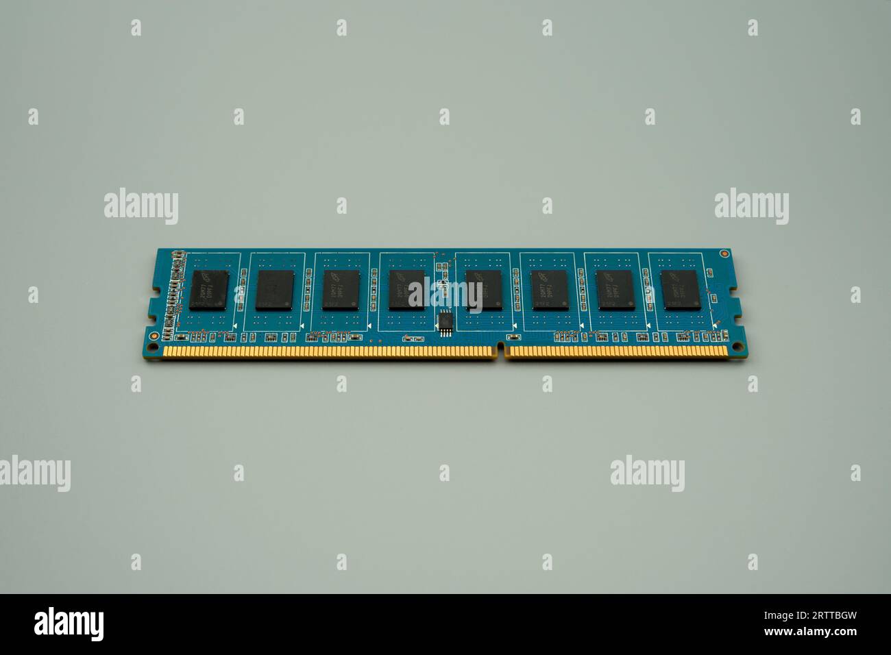 DDR3 memory on a blue PCB, gray background Stock Photo
