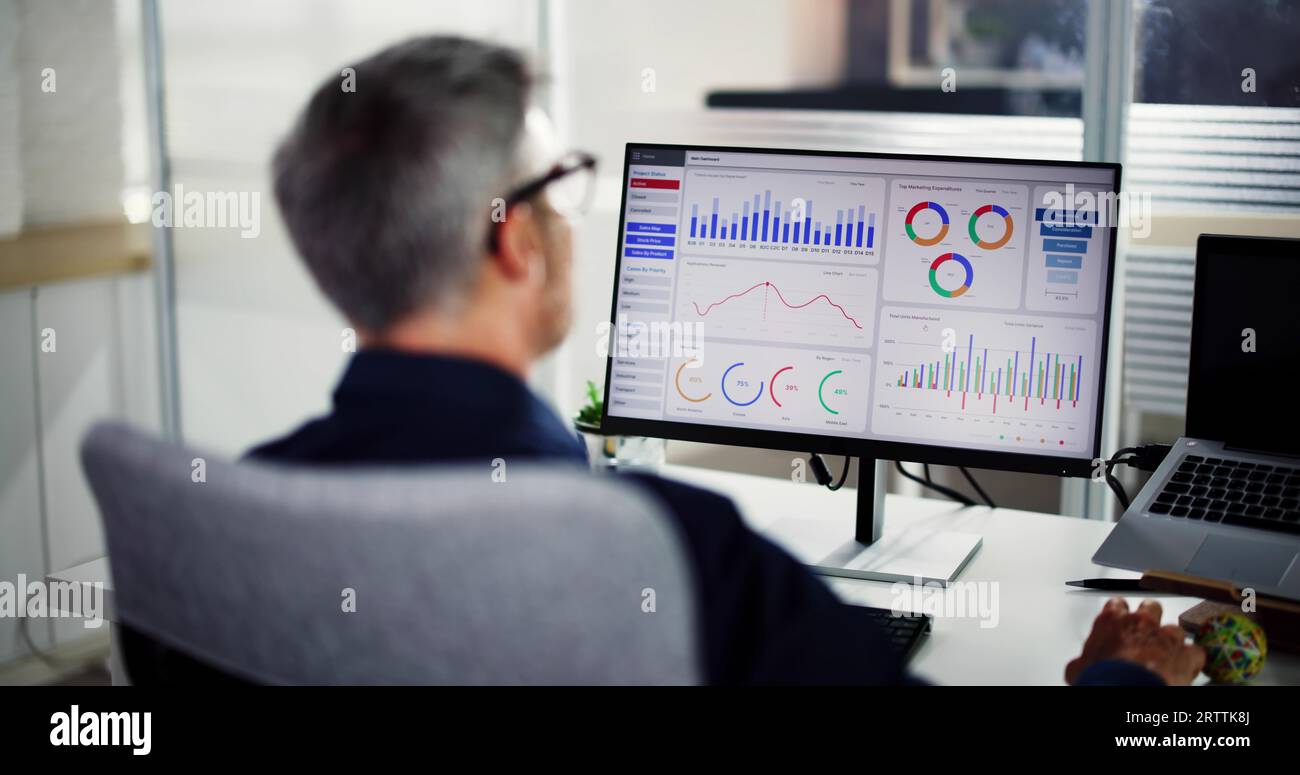 Business Data Analyst Using KPI Data Dashboard On Computer Stock Photo