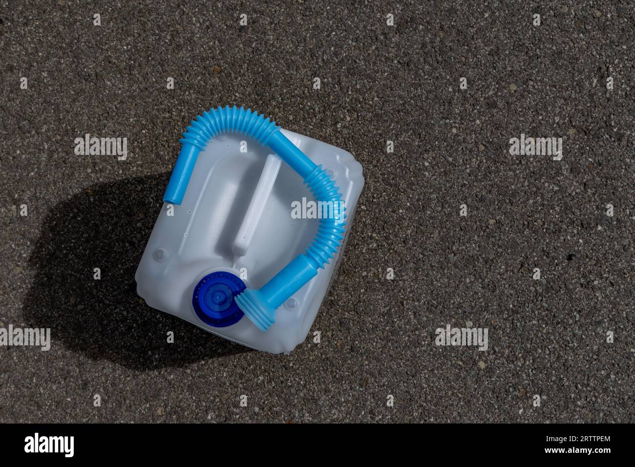 Adblue water fuel canister with funnel in car Stock Photo