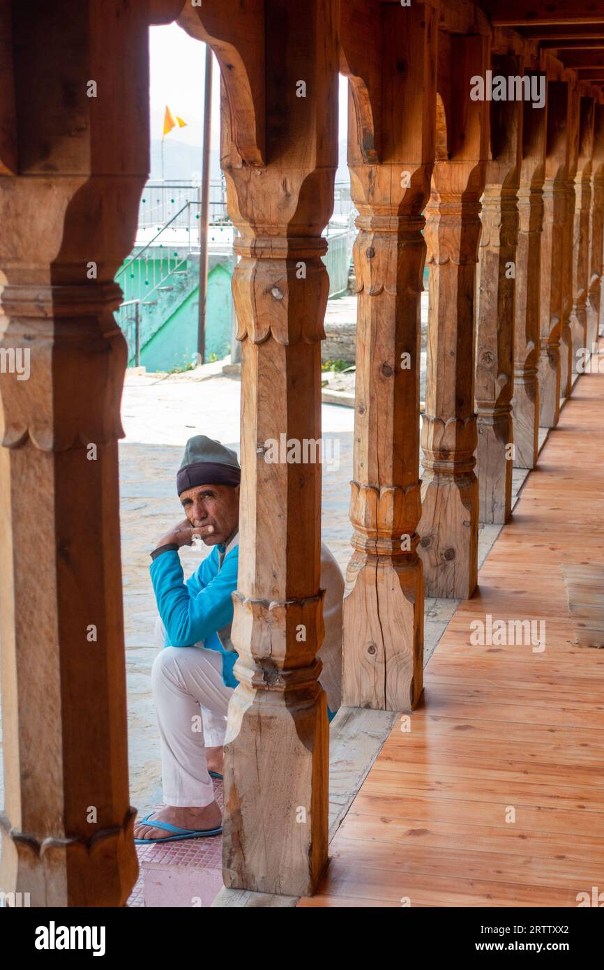 May 8th 2023, Tehri, India. Garhwali local relaxing on the porch of his traditional wooden Uttarakhand home, showcasing rich local culture. Stock Photo