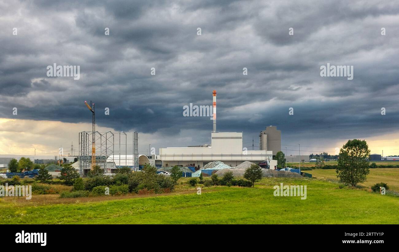 Dark stormclouds gathering over industries in Germany. Stock Photo