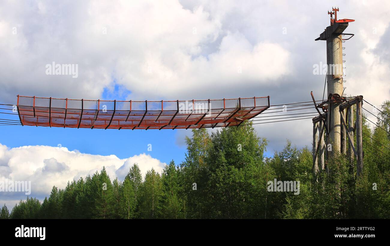 Historic support of Norsjoe ropeway in northern Sweden with safety net above street. Stock Photo