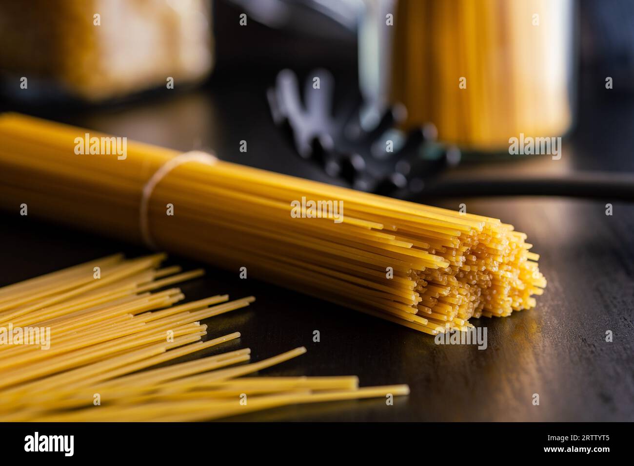 Spaghetti pasta. Uncooked italian pasta on a  black table. Stock Photo
