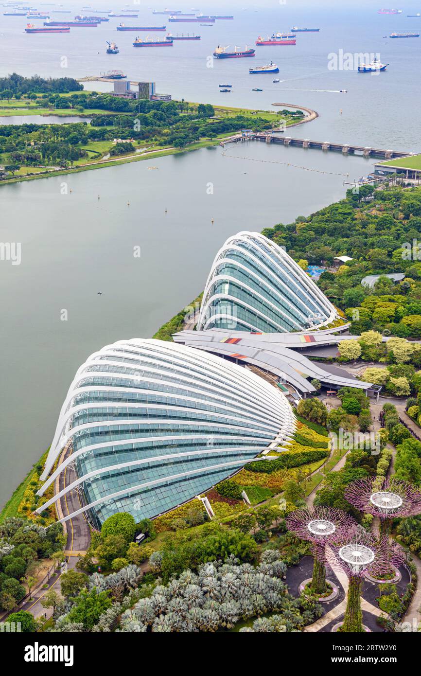 Looking over the Flower Dome and Cloud Forest Conservatory, towards the busy ship filled Singapore Strait, Gardens by the Bay, Singapore Stock Photo