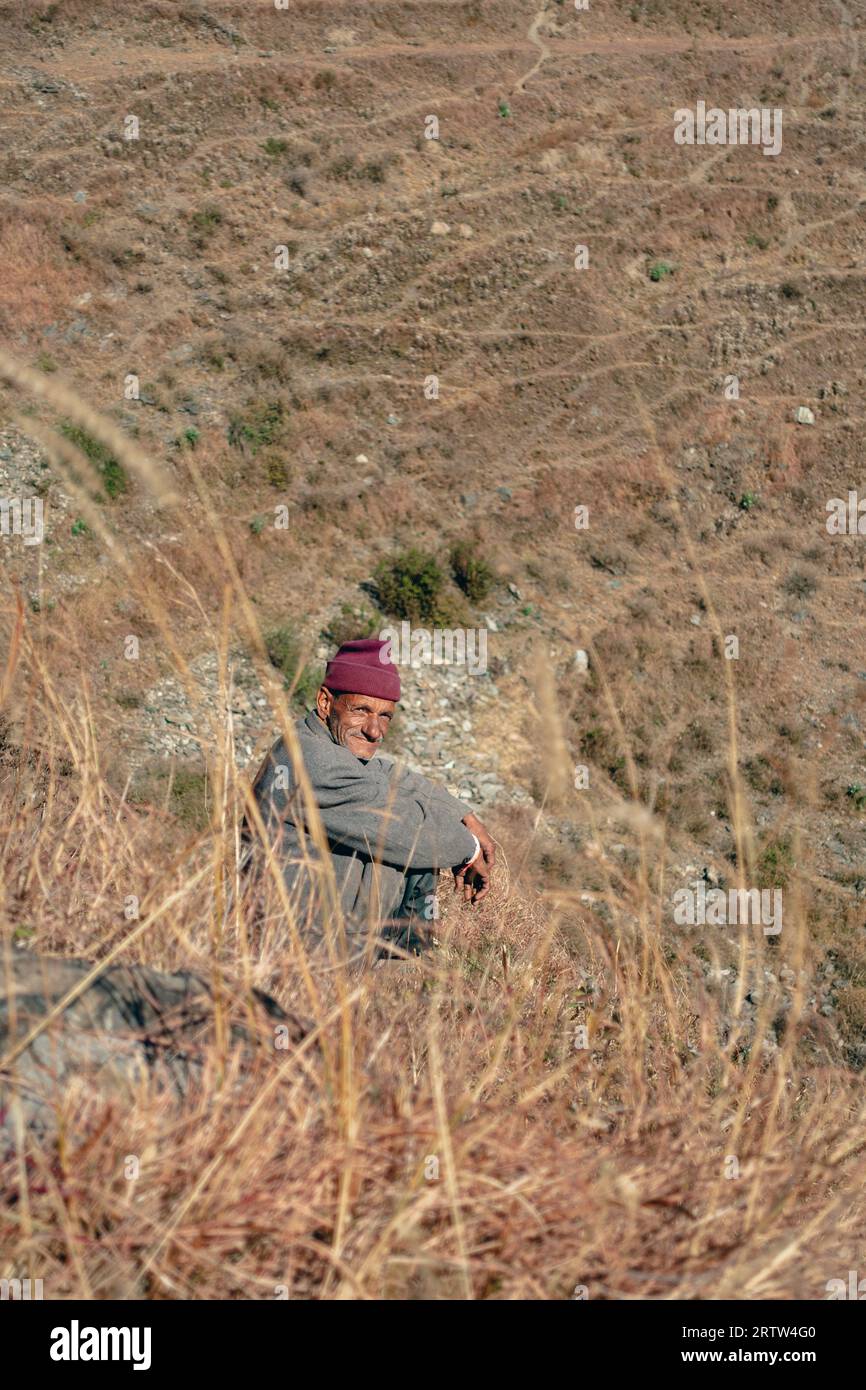 November 30th 2022. Tehri Garhwal, Uttarakhand India. Garhwali man amidst Uttarakhand's mountainous countryside, showcasing the indigenous Garhwali cu Stock Photo
