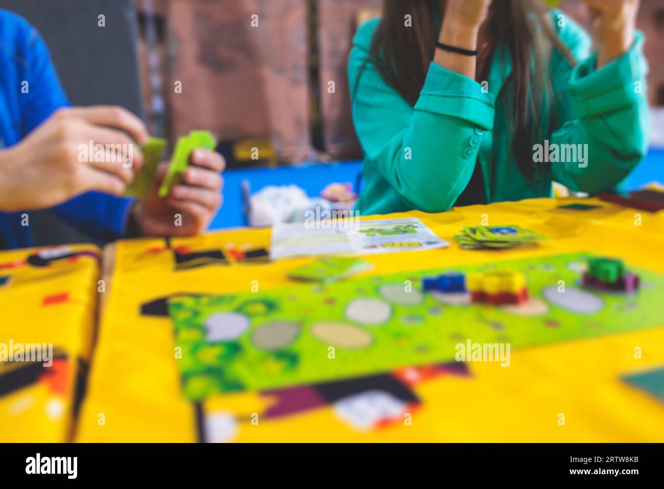 Process of playing board game and having fun with friends and family in