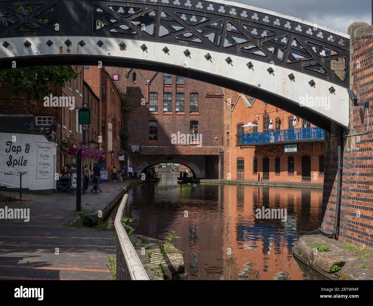 View of the canal at Gas Street Basin, Birmingham, UK; framed by an ornate metal footbridge Stock Photo