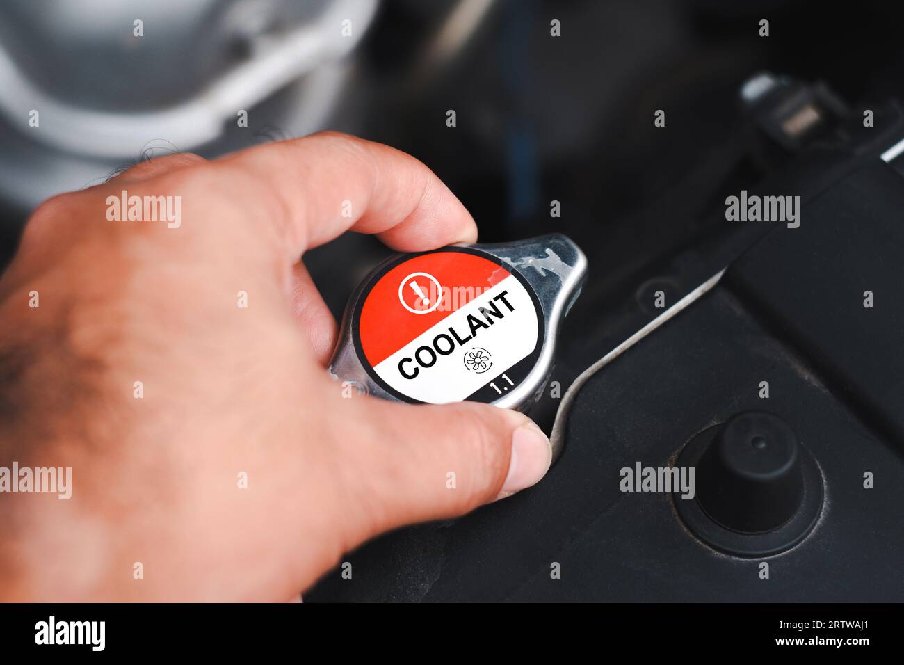 Close up a coolant cap of the car radiator cooling system. Mechanic