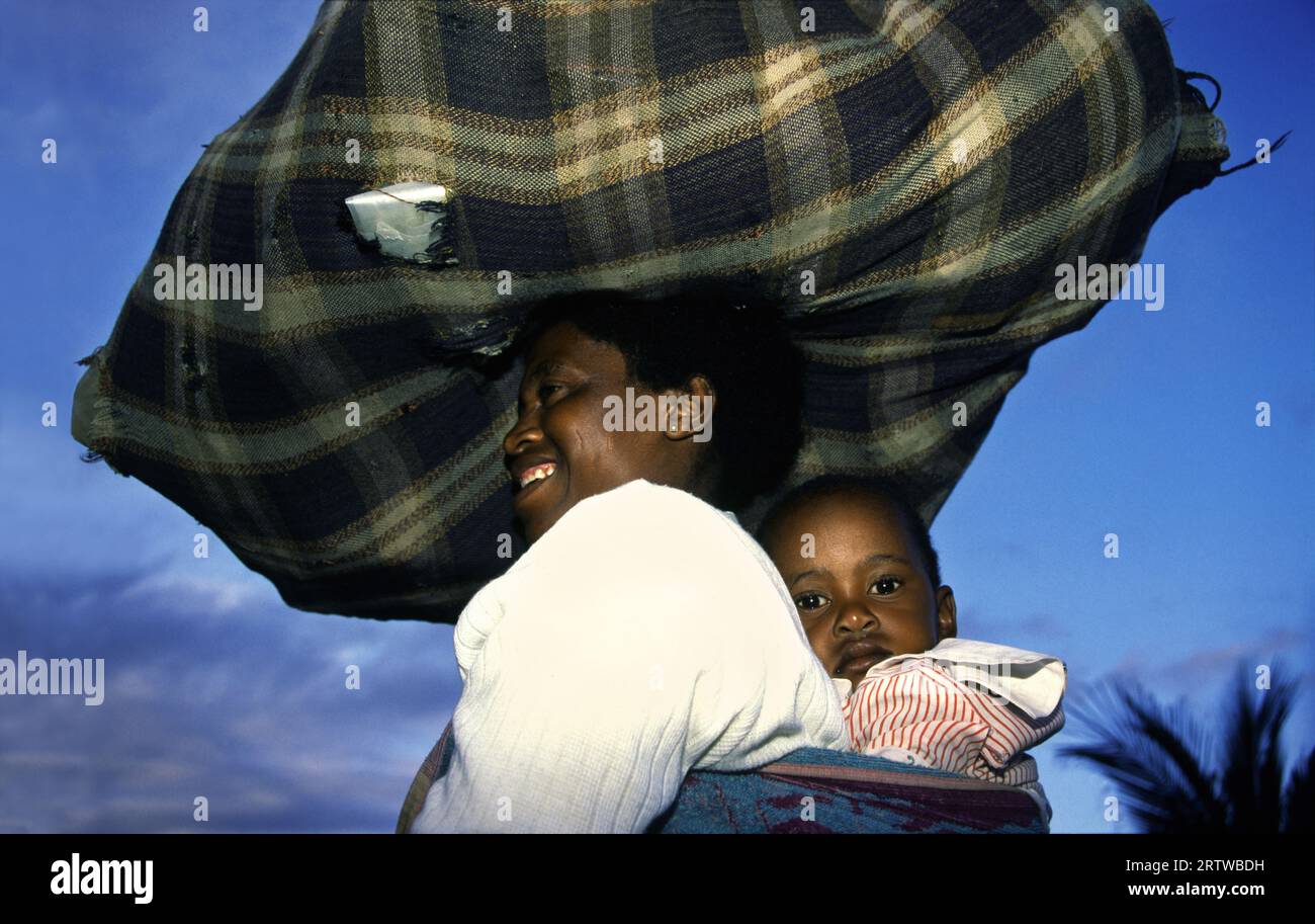 Mother with heavy loads Stock Photo
