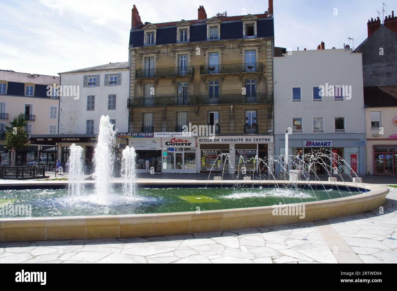 Fountains in Place Charles de Gaulle with shops behind. Vichy, France. Stock Photo