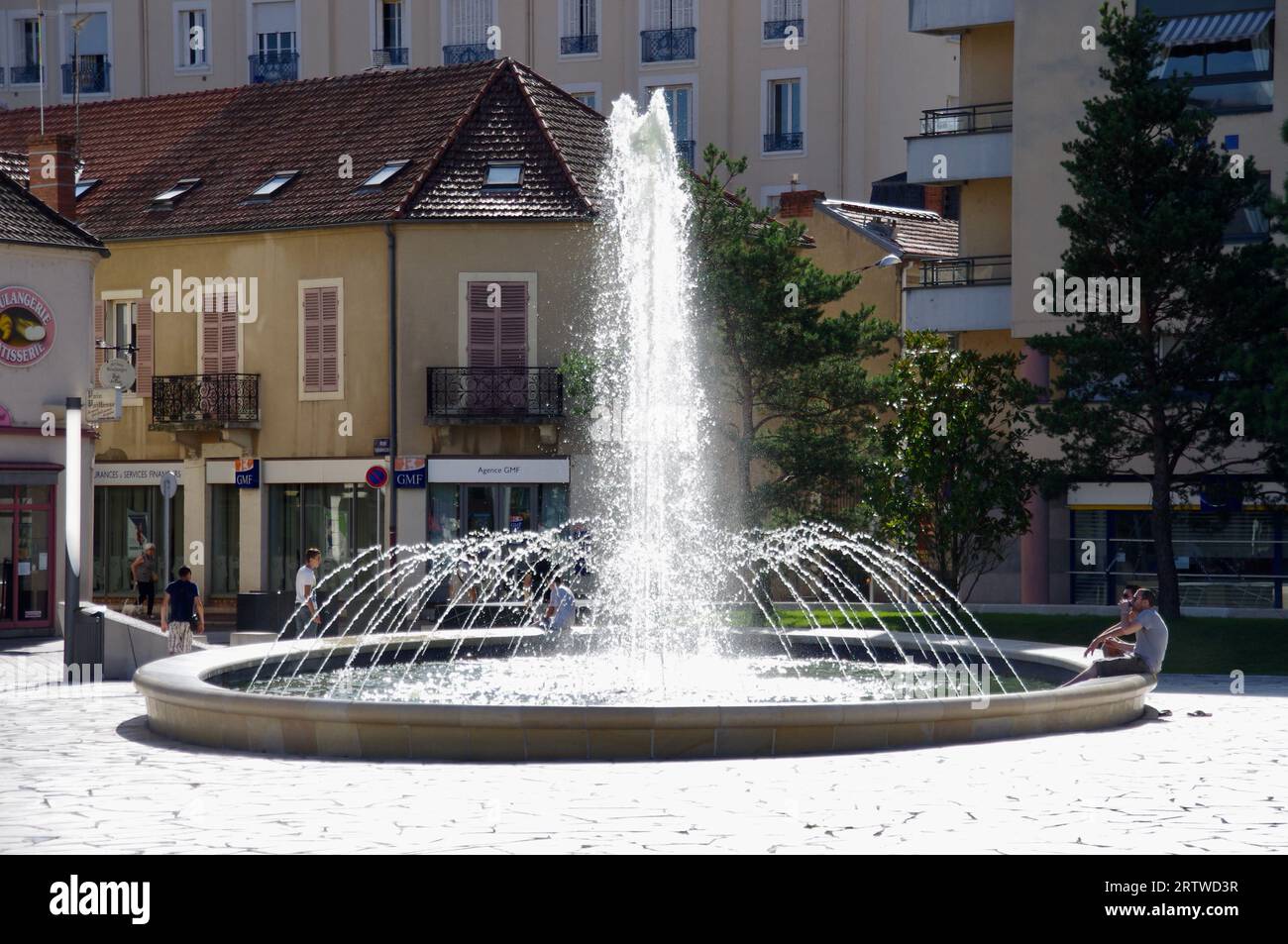 Fountains in Place Charles de Gaulle with shops behind. Vichy, France. Stock Photo